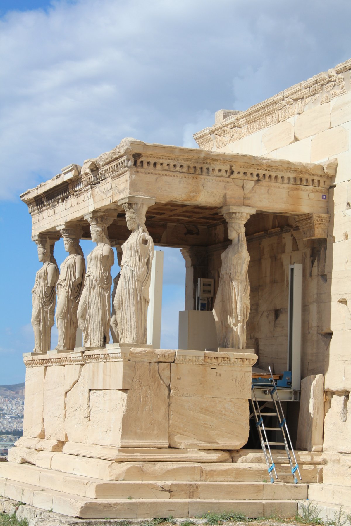 The south porch of the Erechtheion on the Acropolis, with six caryatid statues -- columns carved as standing women -- supporting the entablature above the marble plinth.