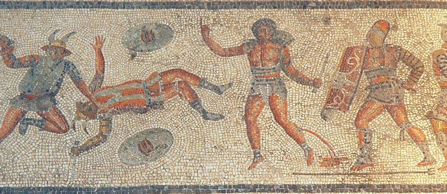 A mosaic from Zliten in modern Libya showing pairs of Roman gladiators fighting with shields and swords, individually labeled with their names above them.