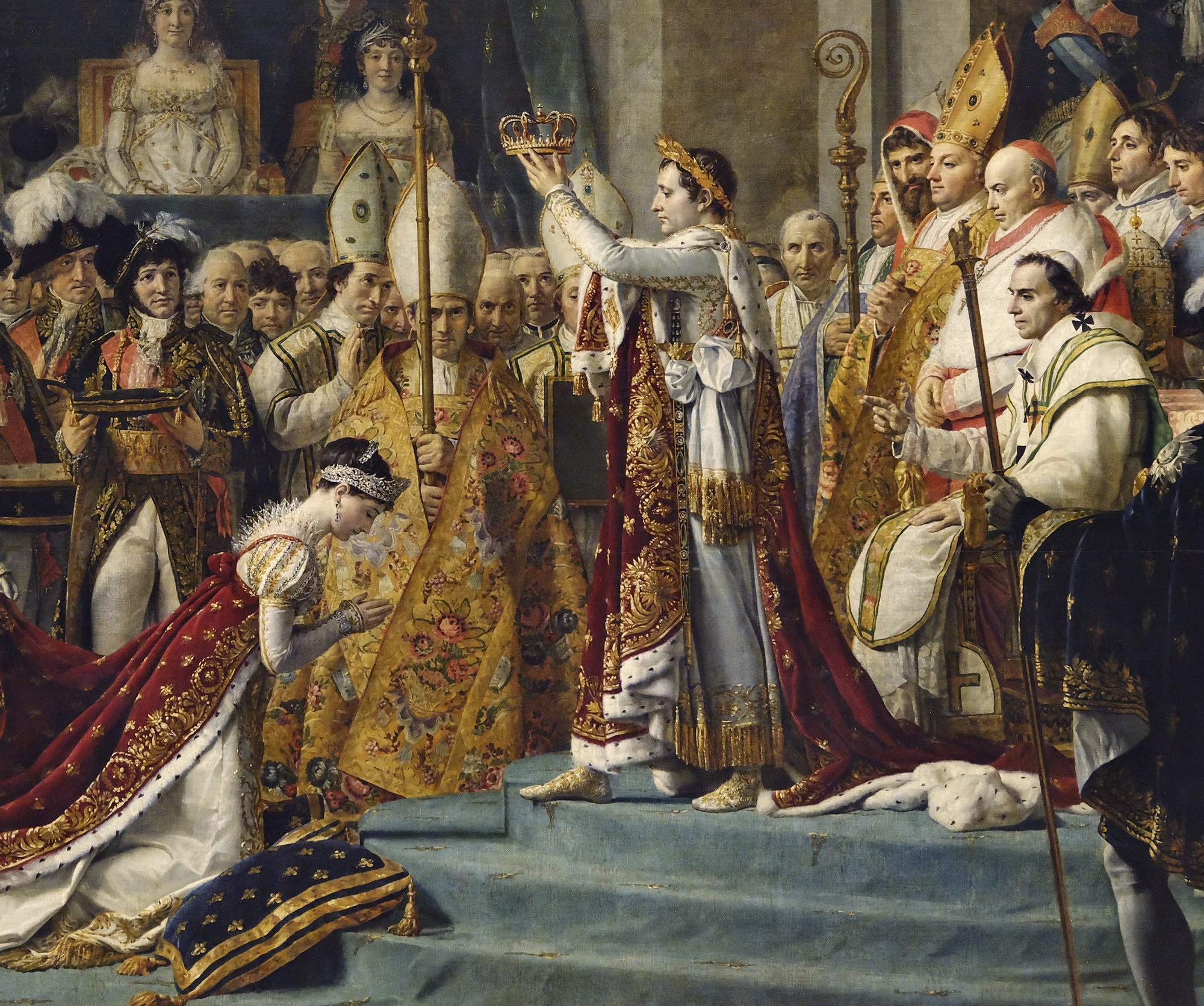 Detail of the painting's centre: Napoleon in a laurel wreath and ermine-lined mantle lifts a small crown above Josephine, who kneels with her hands joined; a feathered courtier behind her holds a cushion.