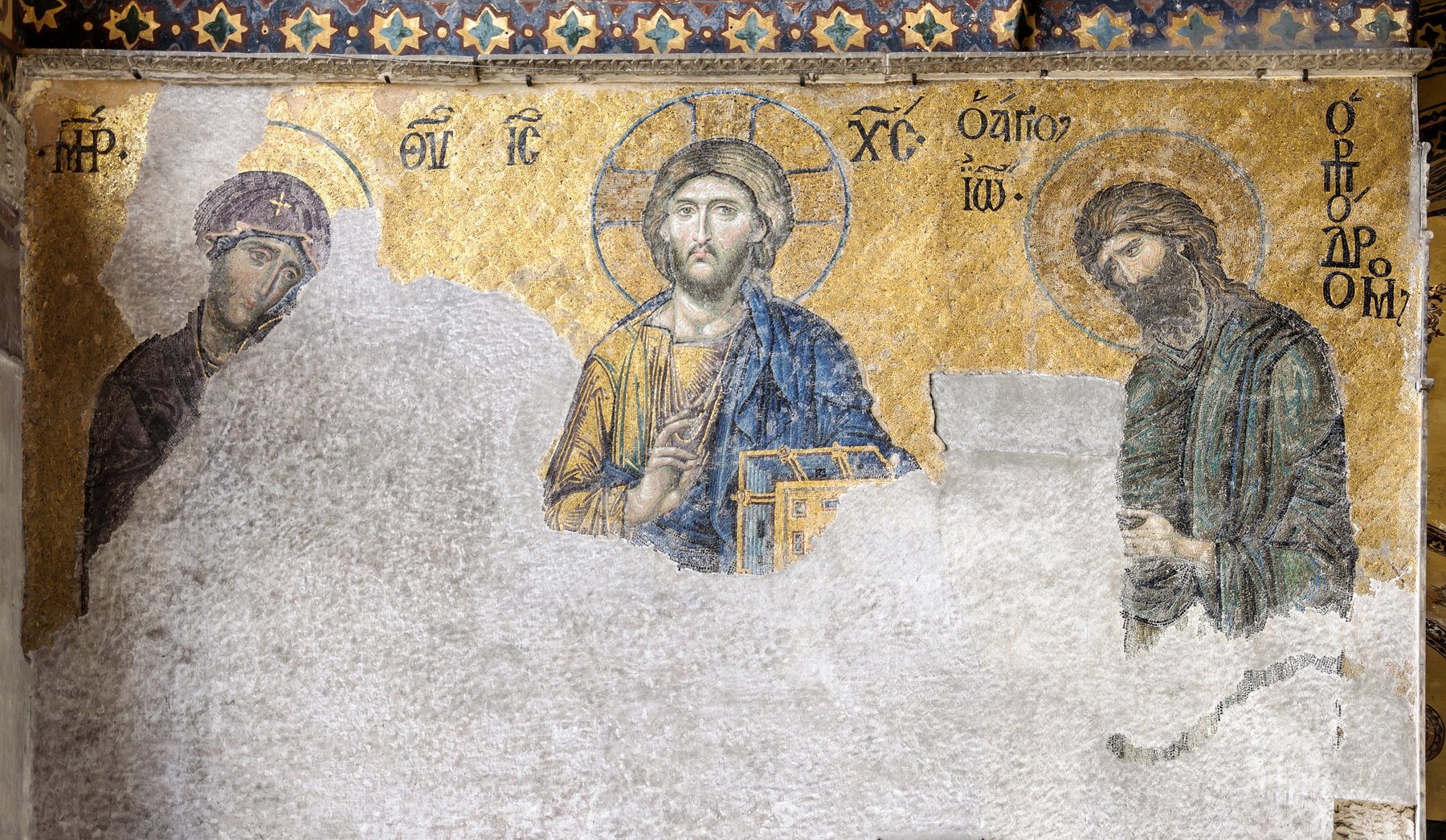 The Deesis mosaic from the upper gallery of Hagia Sophia, showing the head and shoulders of Christ flanked by the Virgin Mary and John the Baptist in golden Byzantine tesserae.