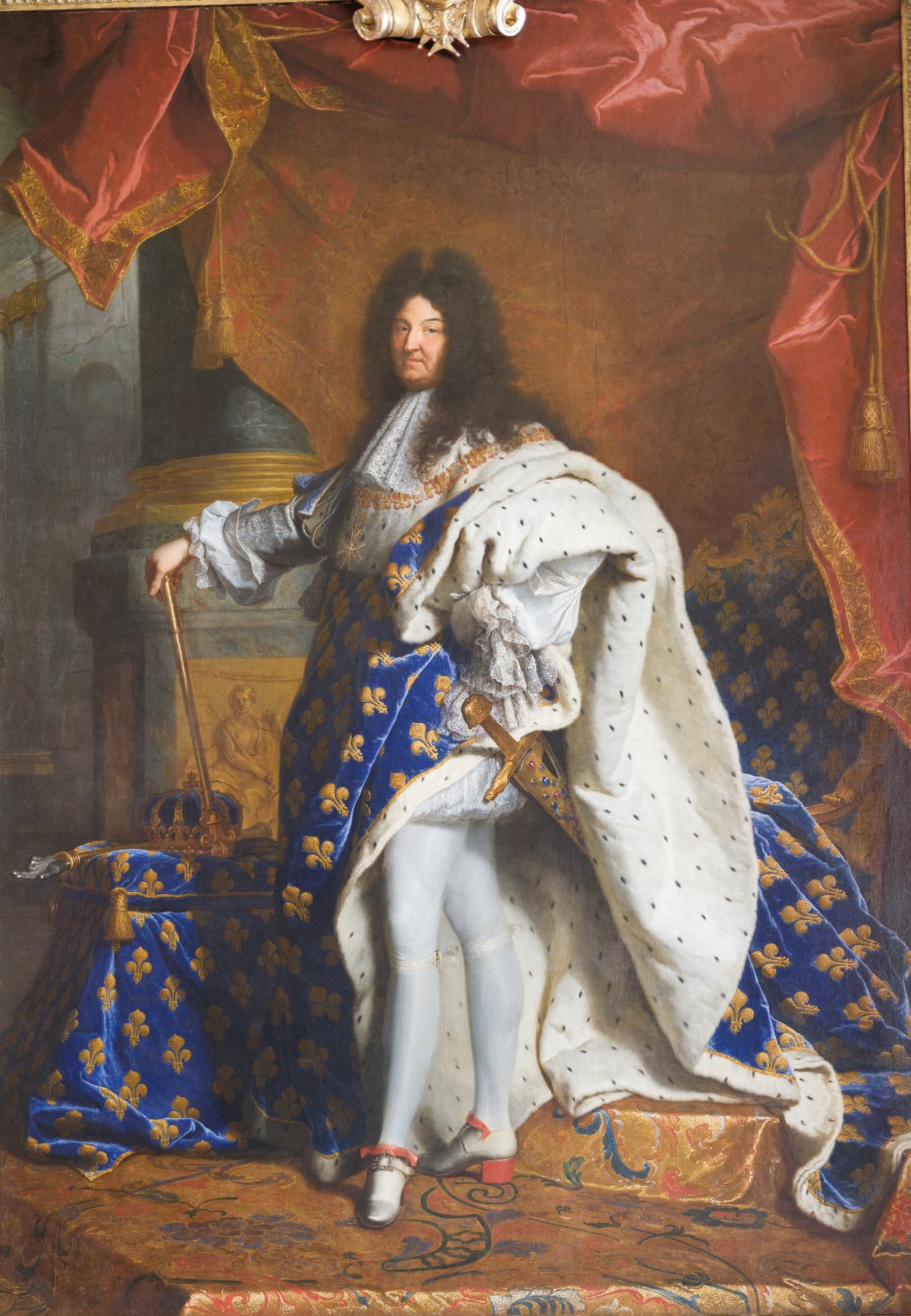 The state portrait of Louis XIV by Hyacinthe Rigaud from 1701, showing the sixty-three-year-old king in full coronation regalia, ermine and fleur-de-lis robes, a long curled wig, and red high-heeled shoes, standing beside a marble column.