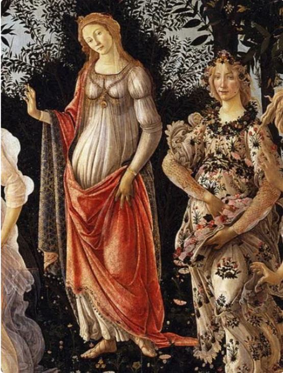Detail of Flora in Primavera: a young woman in a white gown stamped with cornflowers and roses, a wreath in her hair, scattering flowers from a fold in her gown.