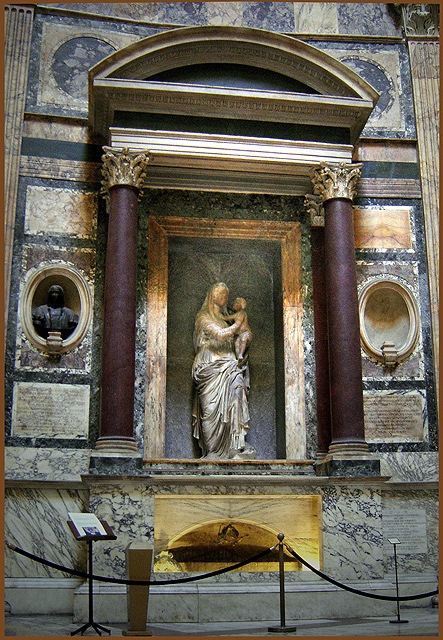 Raphael's tomb inside the Pantheon: a plain sarcophagus beneath a stone niche containing Lorenzetto's small Madonna del Sasso, with Pietro Bembo's Latin epitaph cut into the wall above.